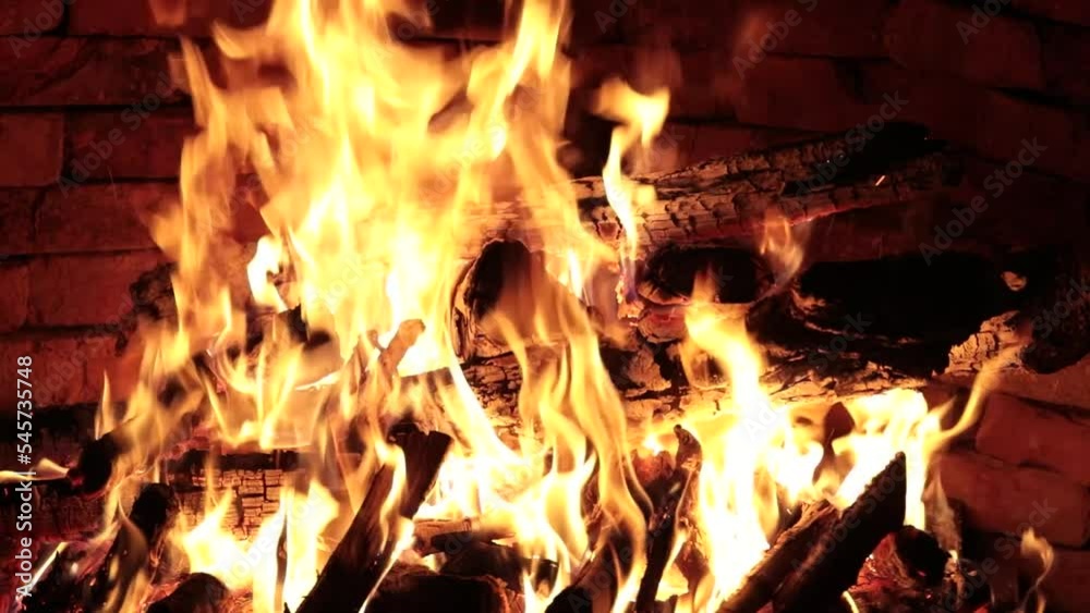 Firewood is burning in the fireplace Firewood is burning in the fireplace