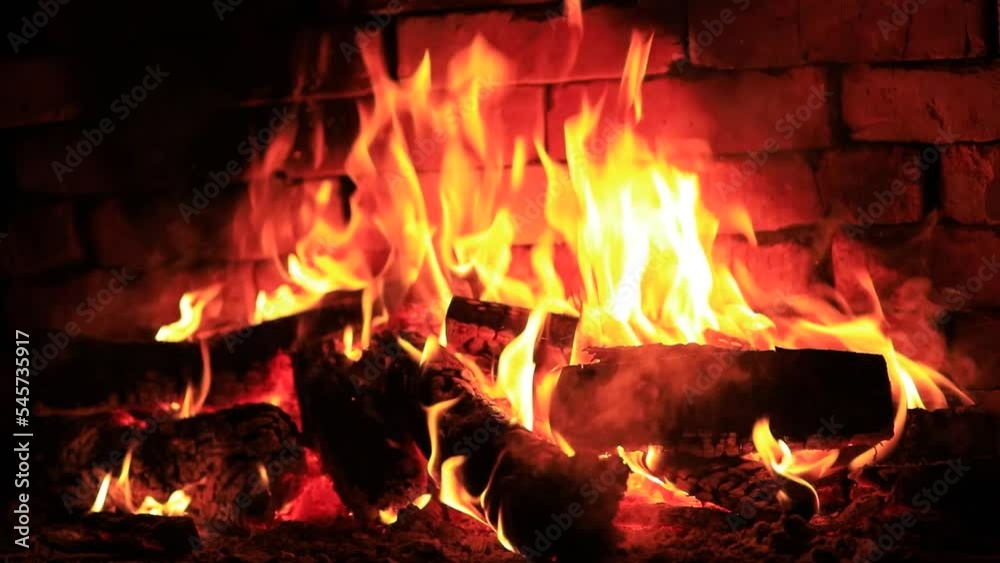 Firewood is burning in the fireplace Firewood is burning in the fireplace