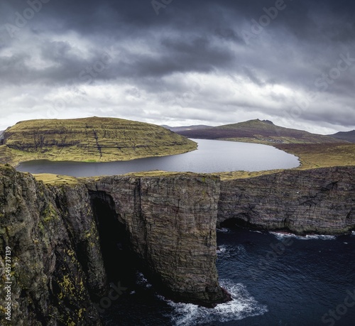 Landscape of Sorvagsvatn lake in the Faroe Islands under gray cloudy sky photo