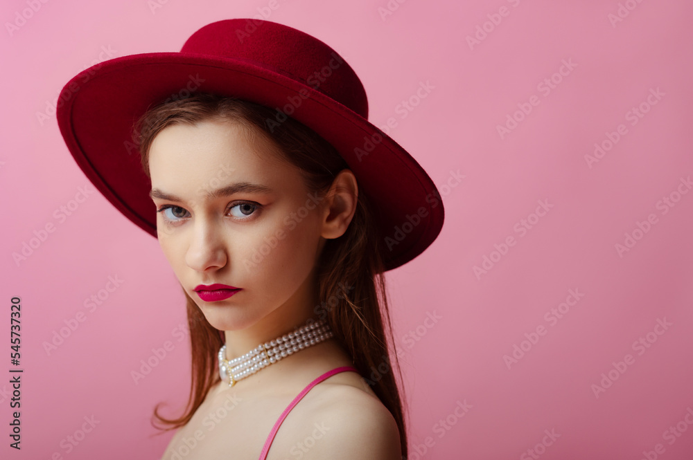 Fashionable beautiful woman wearing dark red hat, trendy pearl necklace. Close up studio portrait. Copy, empty space for text Fashionable beautiful woman wearing dark red hat, trendy pearl necklace. Close up studio portrait. Copy, empty space for text