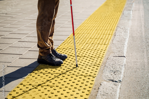 Фотография Close-up of a blind man with a walking stick