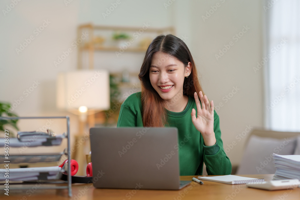 Beautiful young Asian business woman sit on a laptop video conference to discuss work and ongoing business. Beautiful young Asian business woman sit on a laptop video conference to discuss work and ongoing business.