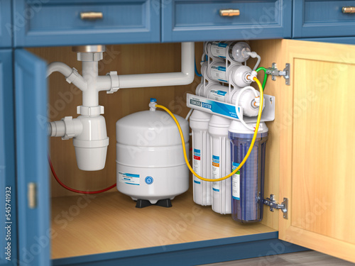 Reverse osmosis water purification system under sink in a kitchaen.  Water cleaning system installation.