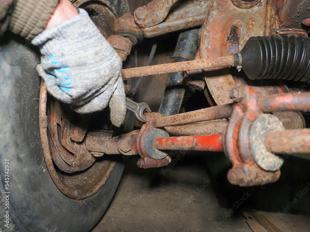 Mechanic is repairing car suspension