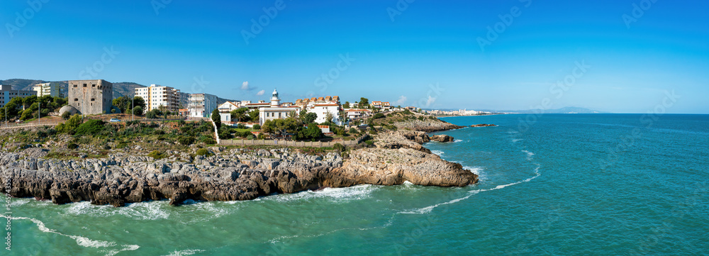 Coastal Panorama view of Oropesa del Mar, Spain, showing cliffs, Torreon del Rey, guard tower and lighthouse