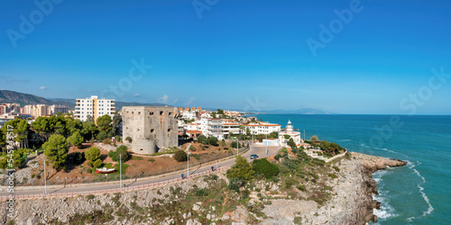 Coastal Panorama view of Oropesa del Mar, Spain, showing blue water, cliffs, Torreon del Rey, guard tower and lighthouse