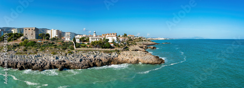 Coastal Panorama view of Oropesa del Mar, Spain, showing cliffs, Torreon del Rey, guard tower and lighthouse