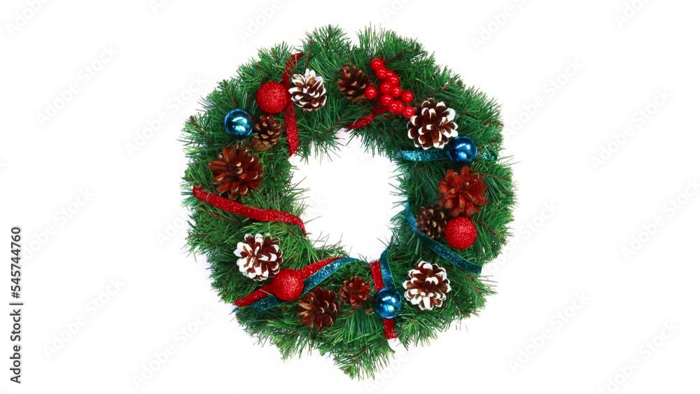 Top view of a bright beautiful Christmas wreath decorated with cones, red and blue Christmas balls, shiny ribbons. A wreath on a white background wraps around its axis, New Year and Christmas concept Top view of a bright beautiful Christmas wreath decorated with cones, red and blue Christmas balls, shiny ribbons. A wreath on a white background wraps around its axis, New Year and Christmas concept