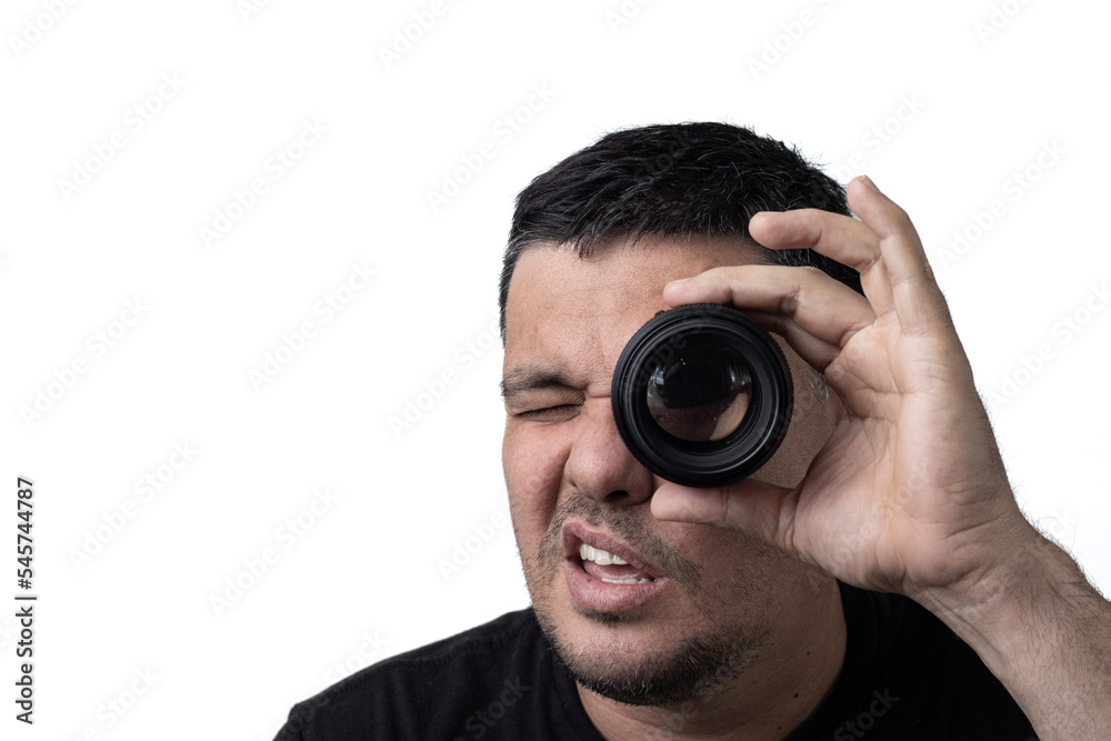 Man watching concentrated through a photographic lens, on a white background. Man watching concentrated through a photographic lens, on a white background.