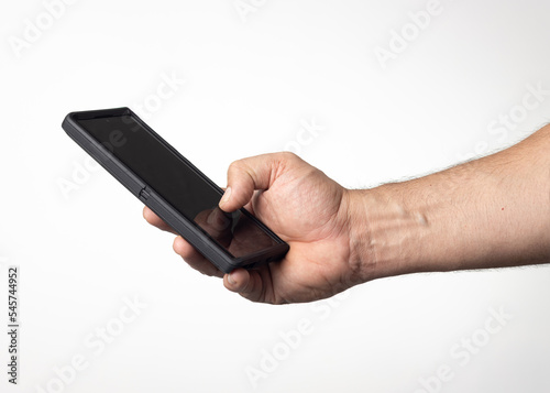 Hand and arm of a man holding a cell phone on a nuclear white background.