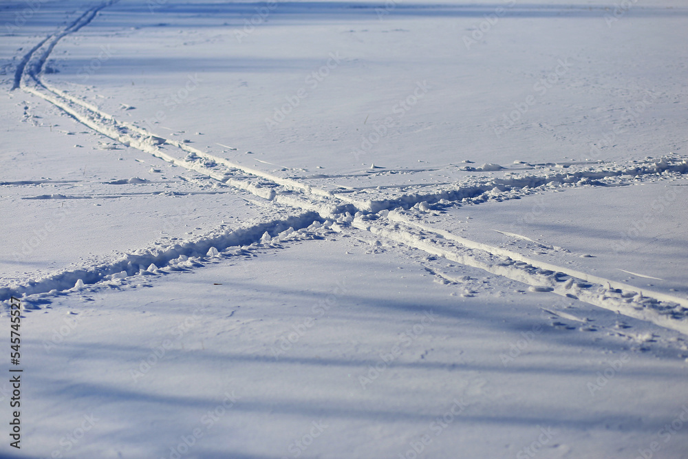 Tracks in the snow on a cold sunny winter day