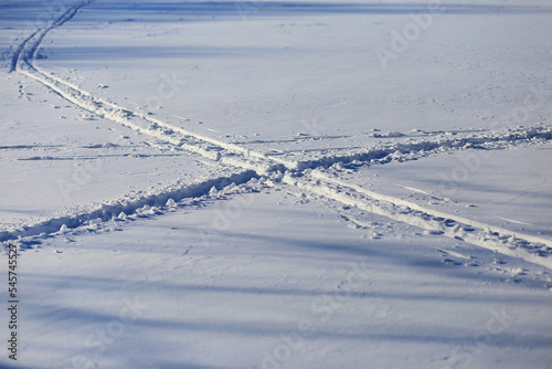 Tracks in the snow on a cold sunny winter day
