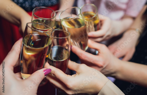 Clinking glasses with alcohol and toasting, party.