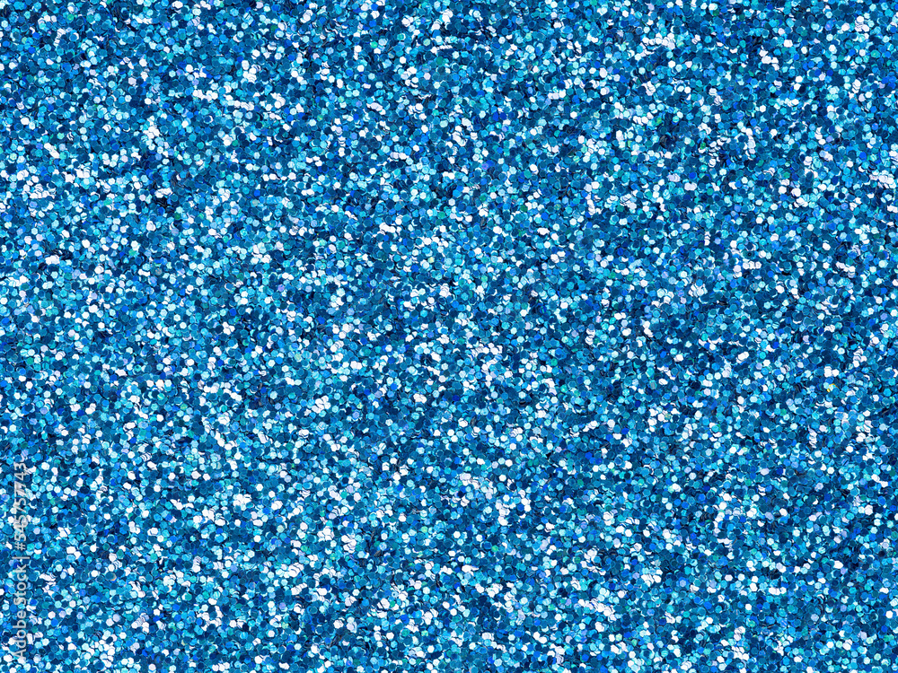 Stockfoto med beskrivningen Bright blue glitter texture. Design pattern of  holographic sparkling shiny glitter for decoration and design of unusual,  extravagant Christmas, New Year, xmas gift card or other holiday pictures.