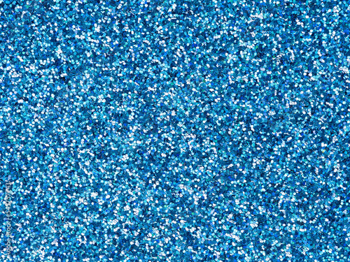 Bright blue glitter texture. Design pattern of holographic sparkling shiny glitter for decoration and design of unusual, extravagant Christmas, New Year, xmas gift card or other holiday pictures.