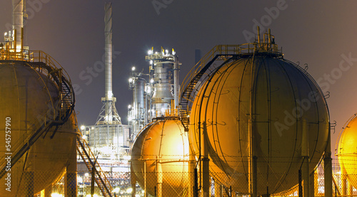 A large oil-refinery plant with Liquefied Natural Gas - LNG - storage tanks