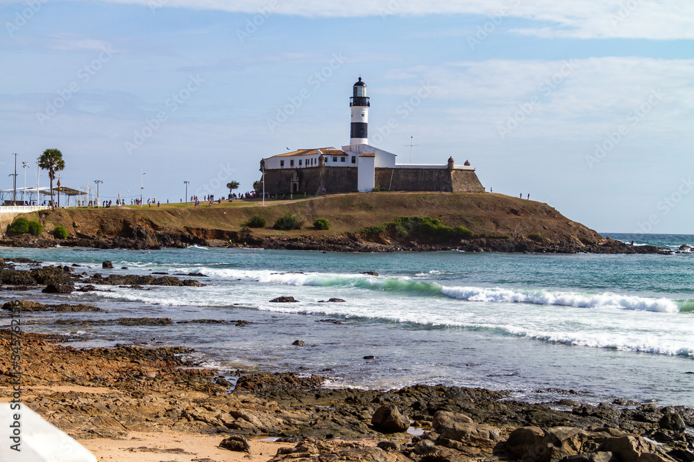 Farol da Barra Lighthouse and beach at Salvador on a sunny summer day. Historic architecture of Salvador, Brazil