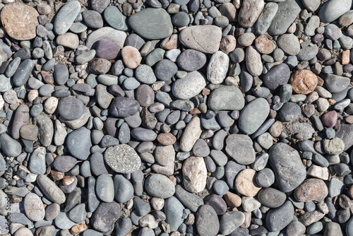 Gray pebble on a sea coast  top view  close-up background texture