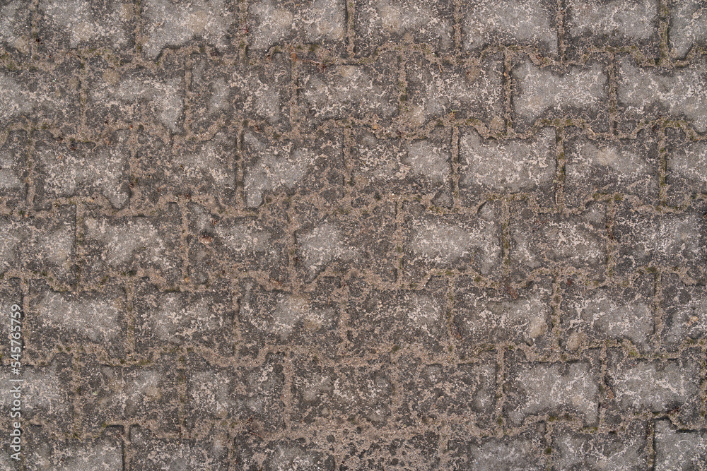Background with wet sand on paving stones after the rain