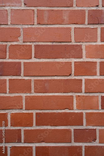 Wall with red bricks as a background with copy space in vertical format
