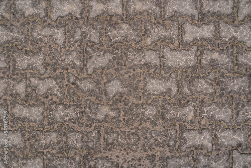 Background with wet sand on paving stones after the rain