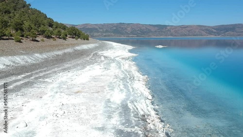 drone footage moving back and elevates slowly at beach of salda lake, burdur, turkey