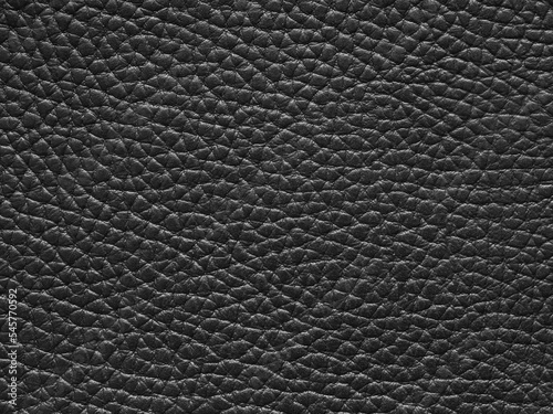 Genuine luxury black leather texture sample. Background with copy space, top view. Leather pattern in dark tone. Faux eco leather. Backdrop textured effect for design, upholstered furniture, clothing.