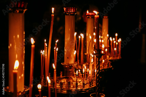 Candles in the church on a black background