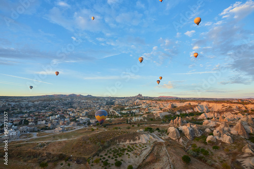 Hot air balloons flying in sunset sky Cappadocia, Goreme, Turkey. Great tourist attraction - sunrise balloning over Cappadocia valleys photo