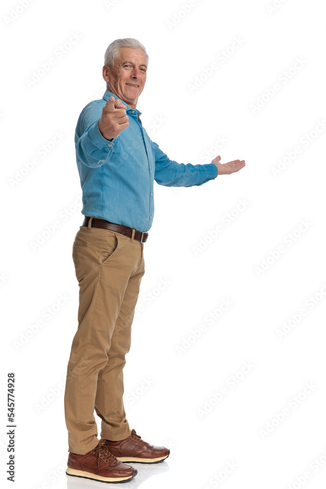 happy old man pointing finger and presenting to side while smiling happy old man pointing finger and presenting to side while smiling