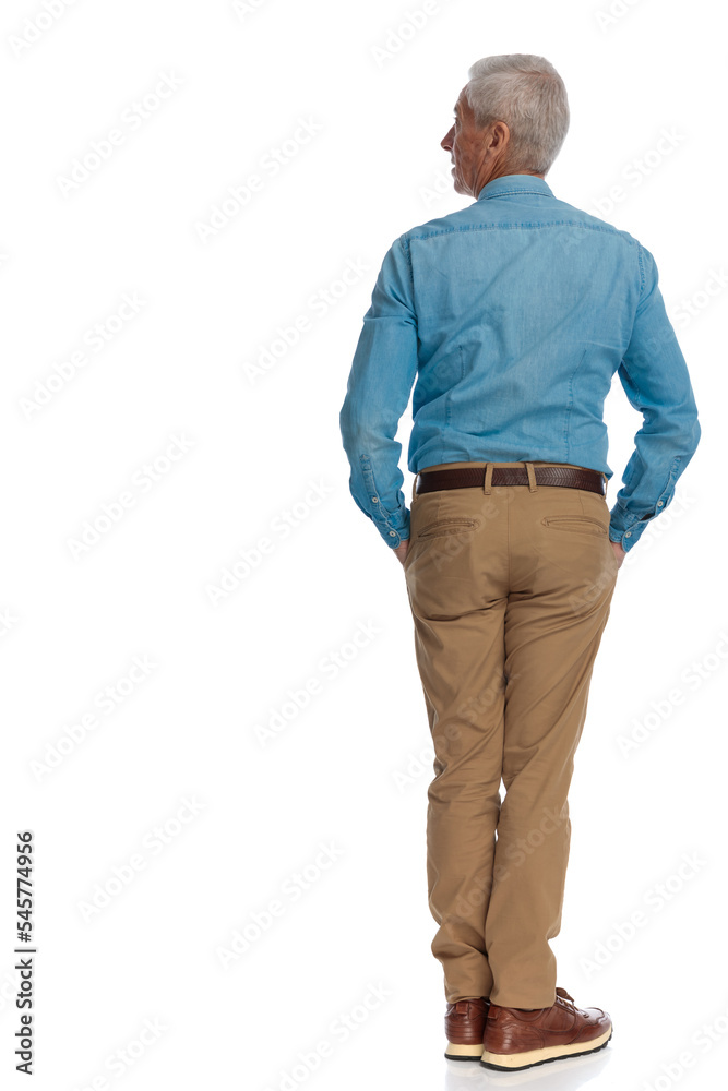 rear view of casual old man with blue denim shirt and chino pants rear view of casual old man with blue denim shirt and chino pants