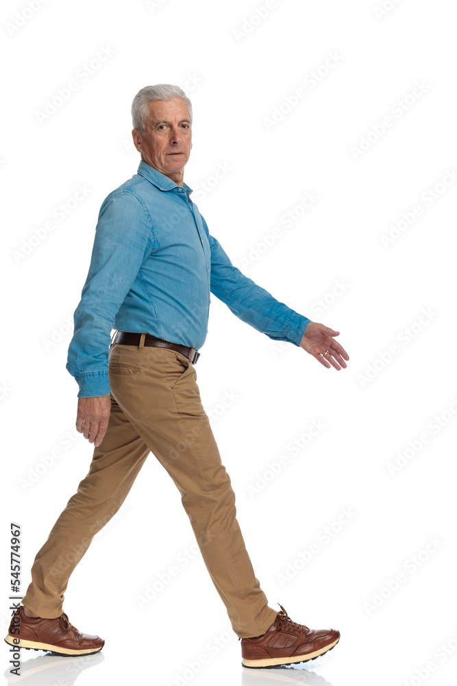 side view of old casual man with sneakers walking and moving side view of old casual man with sneakers walking and moving