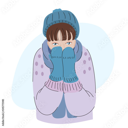 Frozen girl in winter clothes. Woman hides her face in mittens. Sick woman. Person in a hat, mittens, sweater