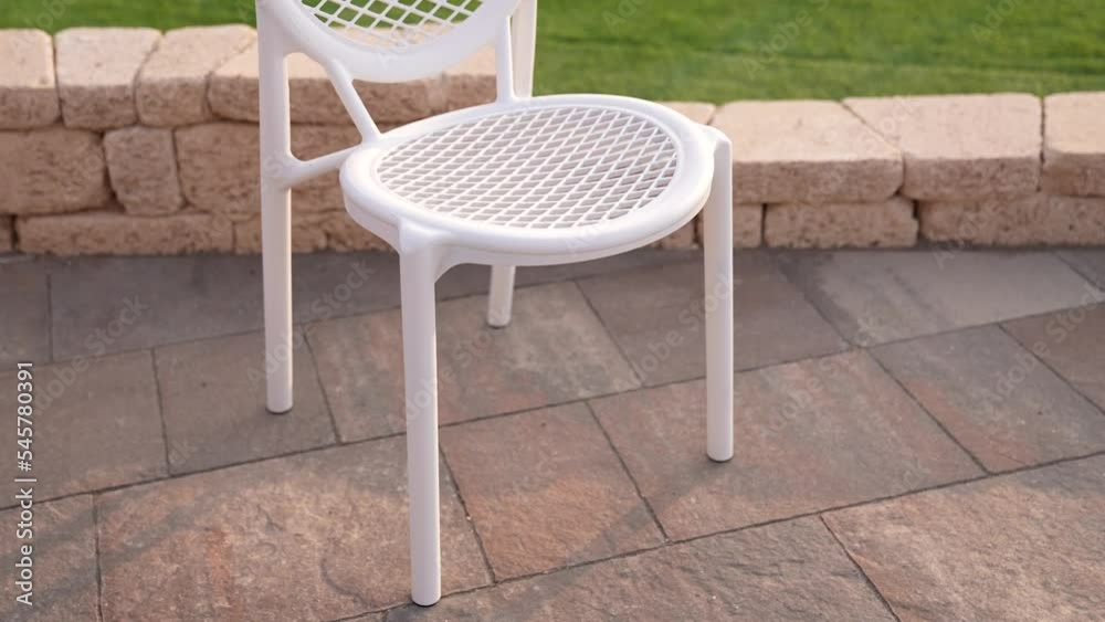 White plastic chair with green grassin the garden,outdoor luxury White plastic chair with green grassin the garden,outdoor luxury