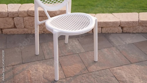 White plastic chair with green grassin the garden,outdoor luxury photo