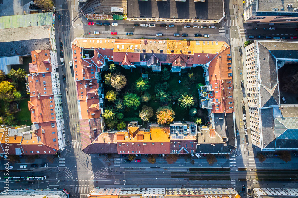 Aerial top down view on a residential block with trees in the yard, located in the city of Graz in Austria