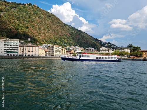 Lake Como country on a summer sunny day. View of the bay. Lake Como and mountains. Scenic view of the resort town. Beautiful Italian landscape.