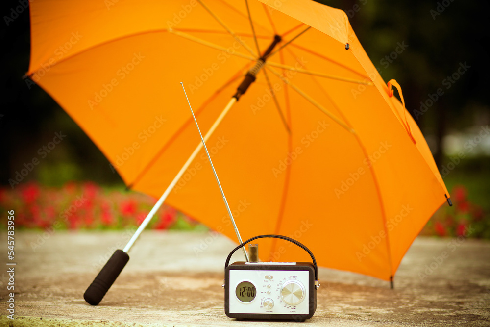 Yellow umbrella and radio receiver on a sunny day