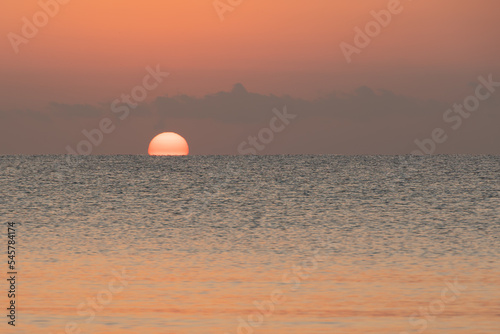 sunrise over the horizon in the sea