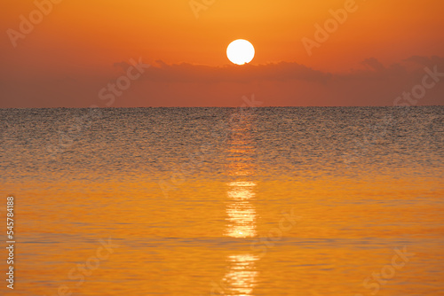 sunrise over the horizon in the sea