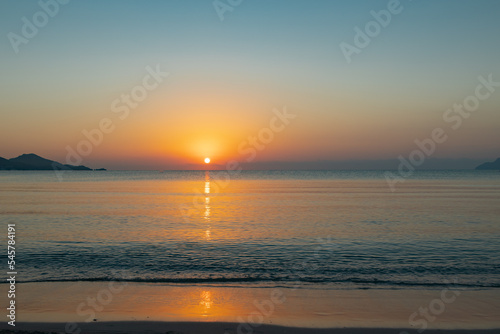 sunrise over the horizon in the sea