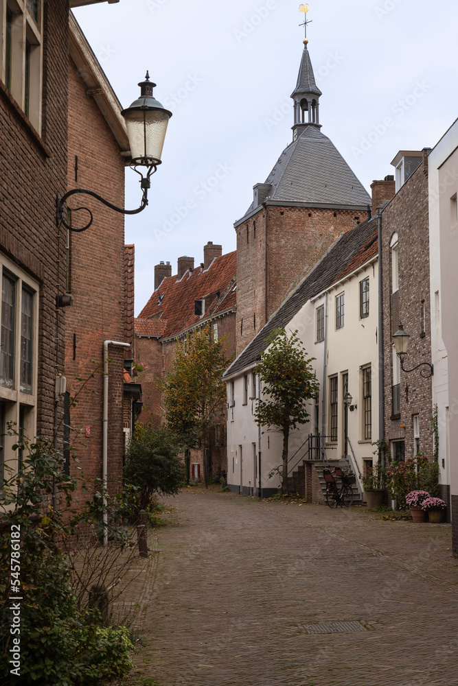Narrow street with a former prison tower - Dieventoren, in the medieval center of the Dutch historic city of Amersfoort. Narrow street with a former prison tower - Dieventoren, in the medieval center of the Dutch historic city of Amersfoort.