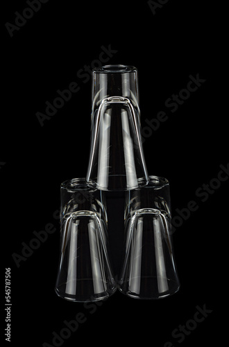 фотографія inverted shiny stacks stacked with pyramid on black background