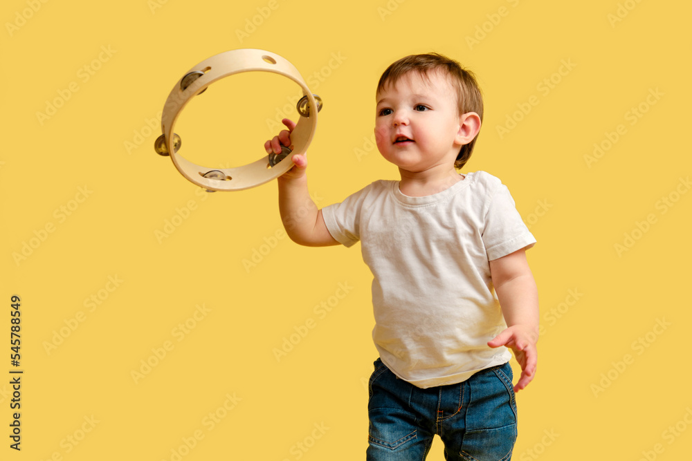 Child Using Percussion Instruments Toddler baby plays the tambourine, a child with a percussion musical ...