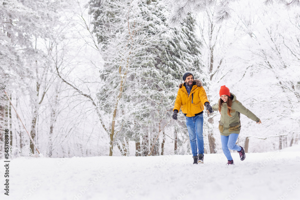 Couple running in the snow