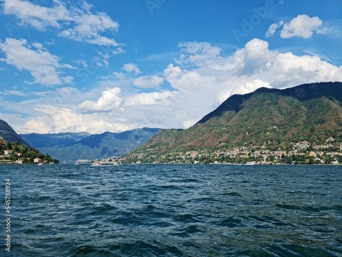 Lake Como country on a summer sunny day. View of the bay. Lake Como and mountains. Scenic view of the resort town. Beautiful Italian landscape.