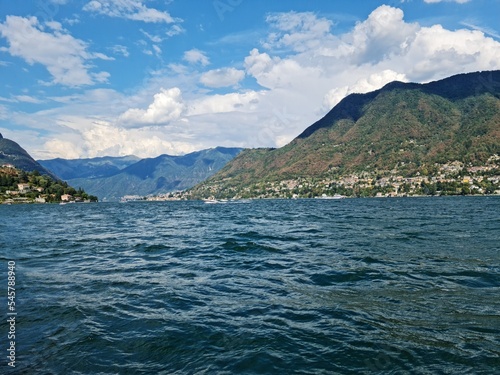 Lake Como country on a summer sunny day. View of the bay. Lake Como and mountains. Scenic view of the resort town. Beautiful Italian landscape.