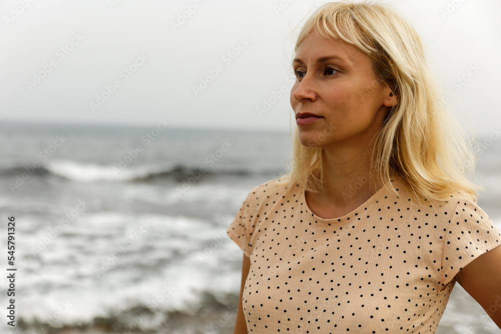 Portrait of a young pretty woman against the background of the sea Portrait of a young pretty woman against the background of the sea