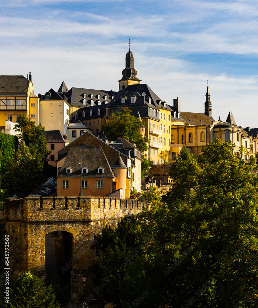 Scenic view of Ville Haute district in historic center of Luxembourg City overlooking Baroque belfry of Saint Michael Church towering over residential buildings..
