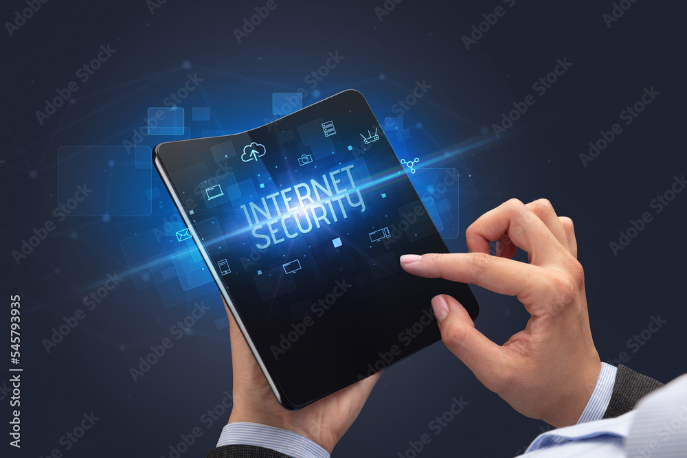 Businessman holding a foldable smartphone, security concept Businessman holding a foldable smartphone, security concept